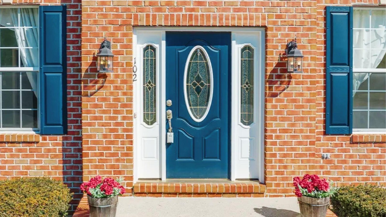 Blue steel exterior door with decorative insulated glass and sidelights for cold weather protection