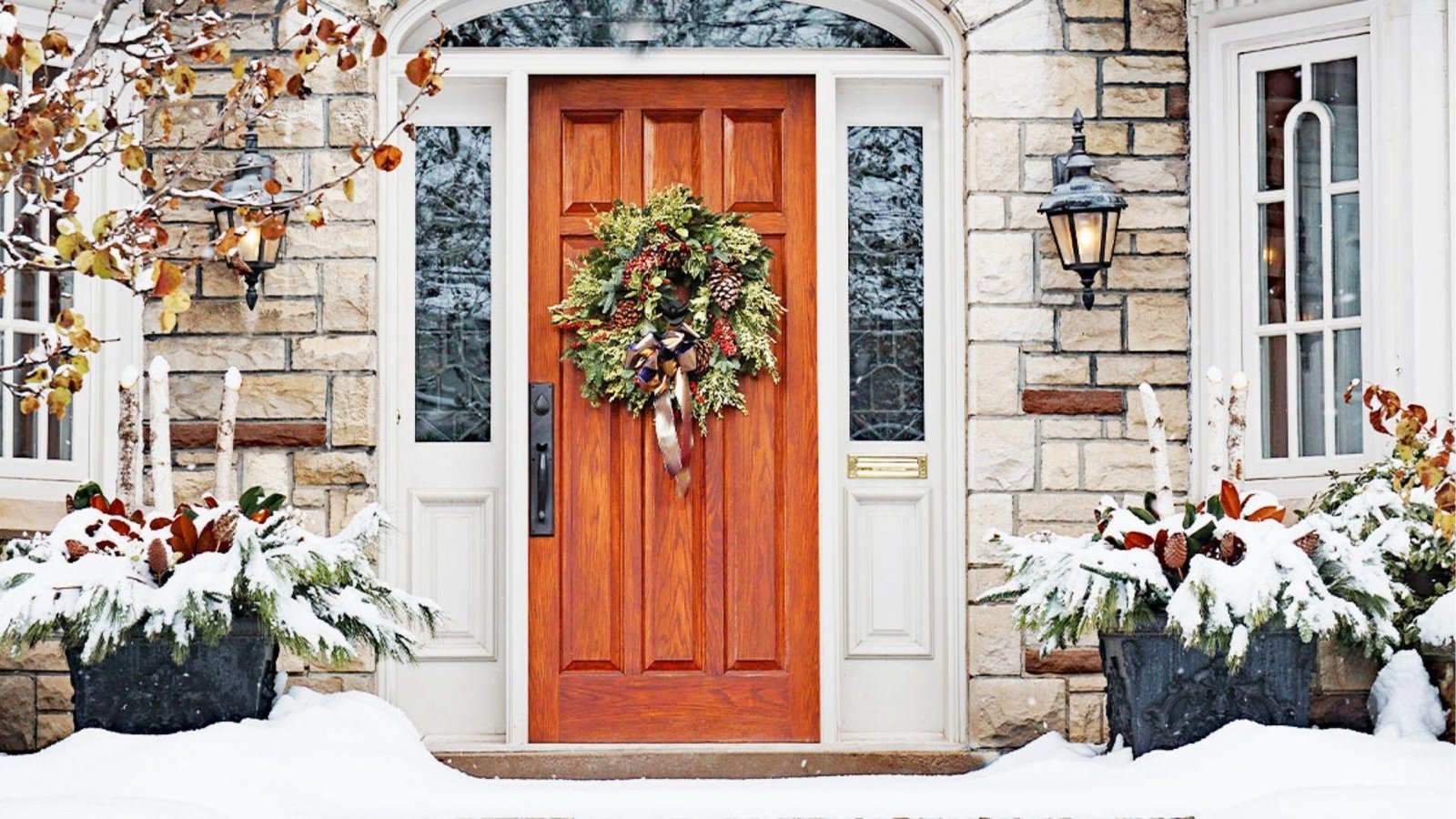 Warm wood exterior door with insulated glass sidelights and winter wreath perfect for cold weather entryways
