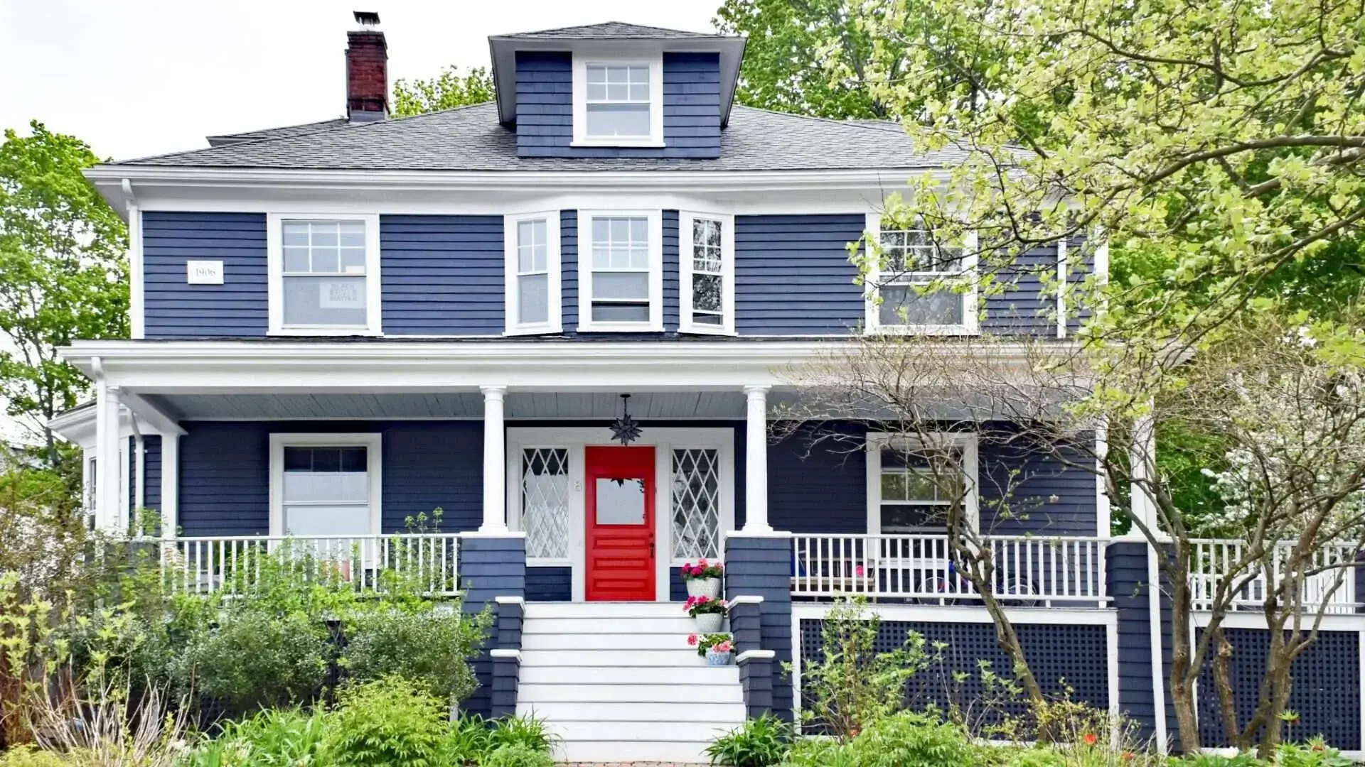 Blue house with a visually striking front door demonstrating the impact of color on curb appeal.