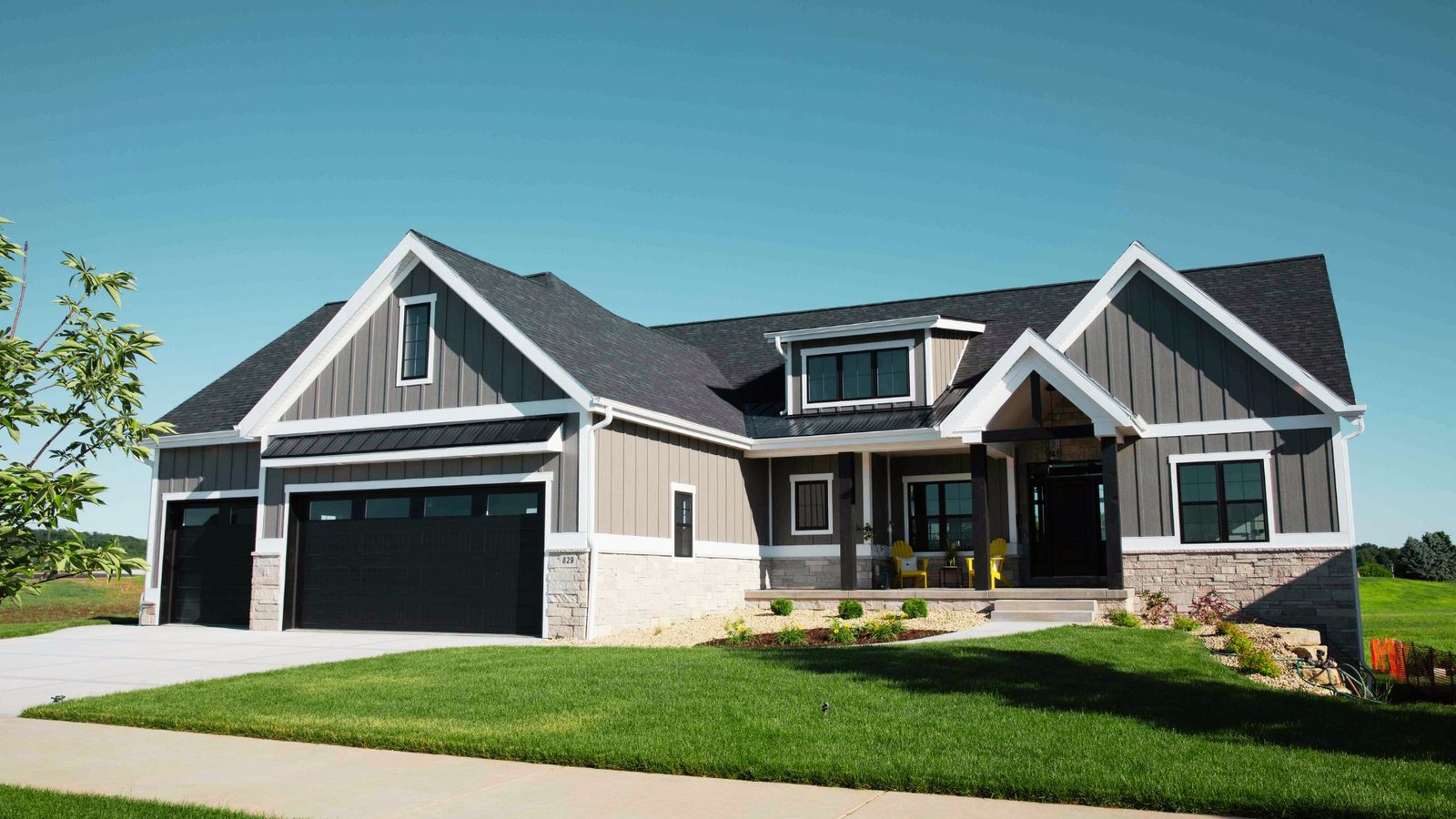 Image showing the grey house black garage door.