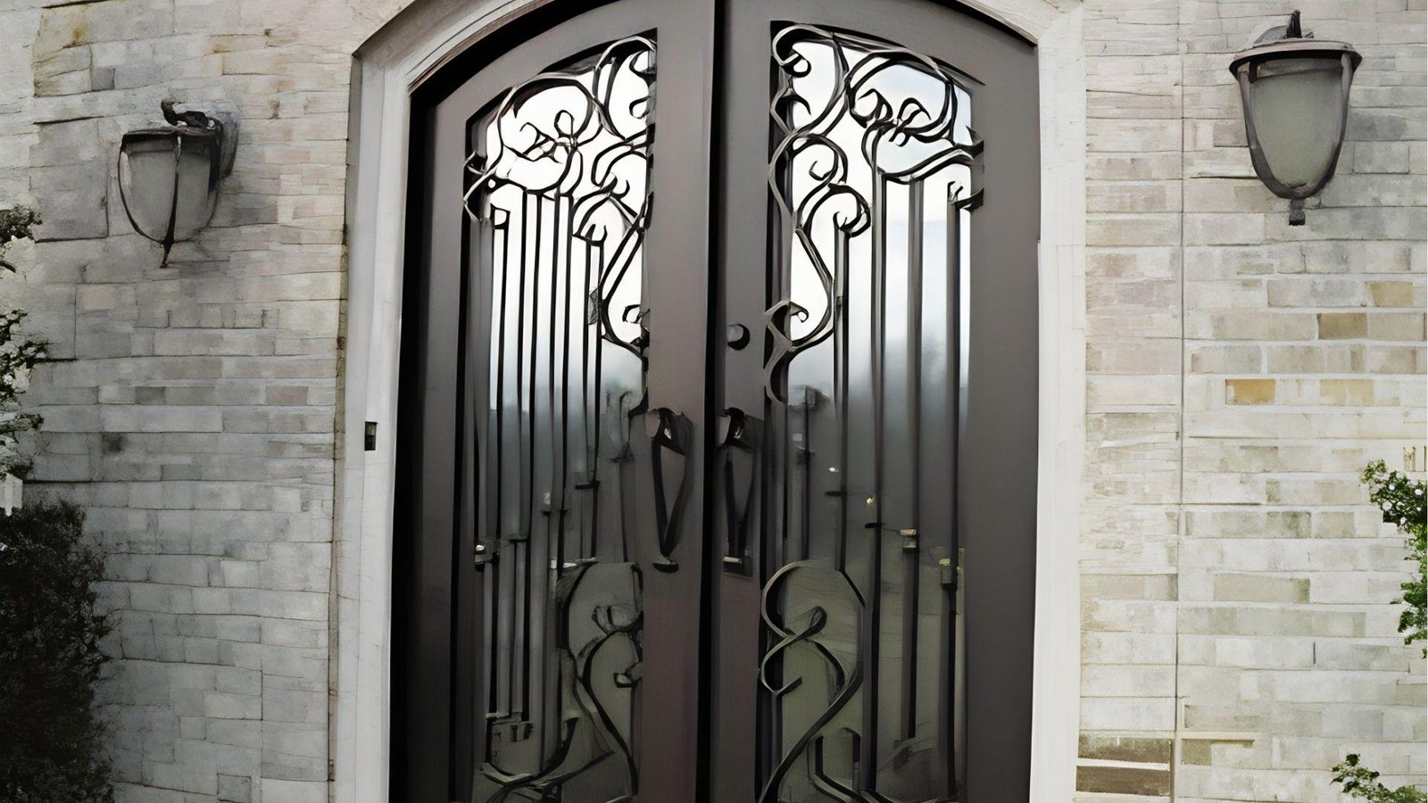 Arched wrought iron double exterior doors with thermal break technology suited for cold climates