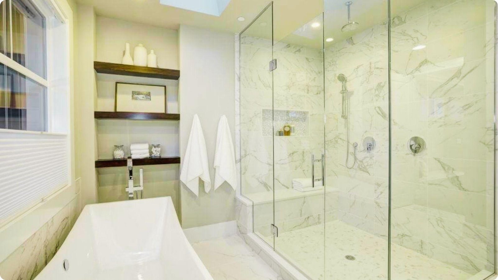 Spacious bathroom with a large semi frameless glass shower enclosure next to a freestanding tub.