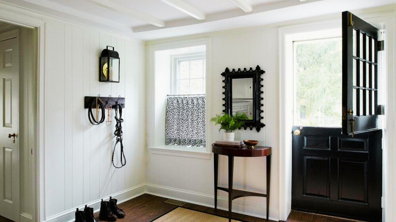Black and white farmhouse board and batten entryway with modern accents.