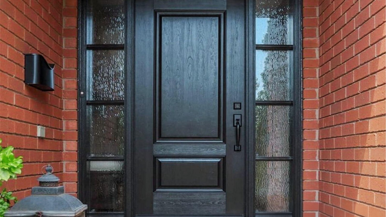 Black fiberglass exterior door with rain glass sidelights offering durability and insulation for cold weather